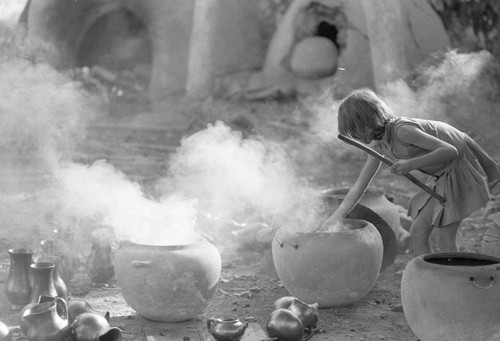 Girl with smoking clay jugs, La Chamba, Colombia, 1975