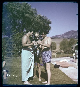 Milner family party, man in towel with woman & man in bathing suits, Ojai, Calif., ca. 1950s