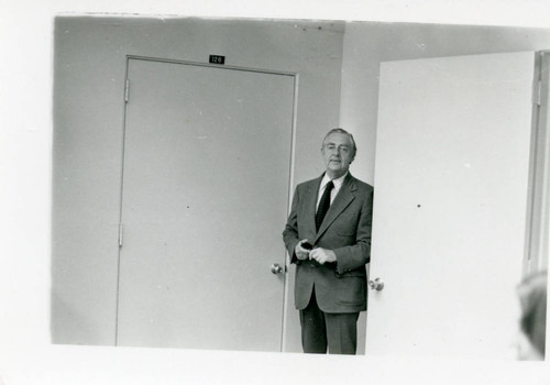 Dr. Tegner standing at the door of his office (Pose 1)