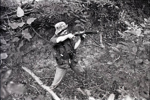 Survival school student holds a rifle, Liberal, 1982