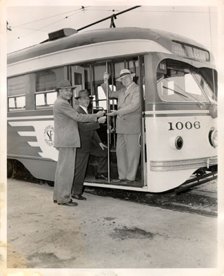 [V. S. Herrington, James H. Turner and W. H. Scott posing with an L line streetcar]