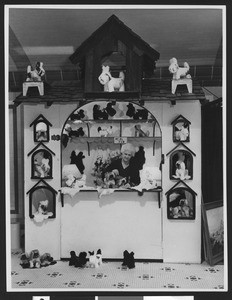 Woman tending an exhibit of real fur stuffed animals at a Chamber of Commerce exhibit, ca.1930