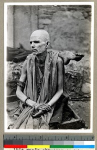 Hindu man putting his foot over his shoulder to seek religious merit, Vārānasi , India, ca. 1920