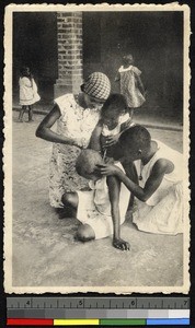Girl having her hair cut, Mangembo, Congo, ca.1920-1940
