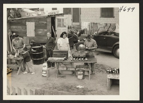 The backyard garage of Yam Okamuro in Glendale, California. Left to right, Mr. Okamuro, Dennis Okamuro (Mrs. Hara's little nephew)