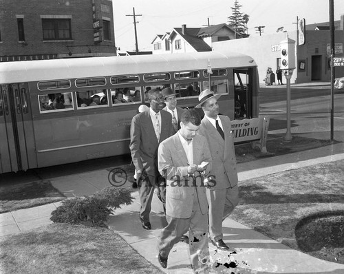 Men walking near a bus, 29th St., Los Angeles, 1955