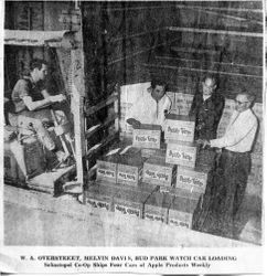 William A. Overstreet, Melvin Davis and Bud Park in the Sebastopol Co-op plant watching Apple Time products being loaded in railroad car