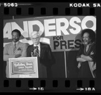 John B. Anderson at podium with Paul Winfield and Cecil Williams during presidential campaign in San Francisco, Calif., 1980