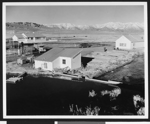 Small buildings adjacent to a unidentified body of water (Los Angeles Aqueduct?), ca.1940