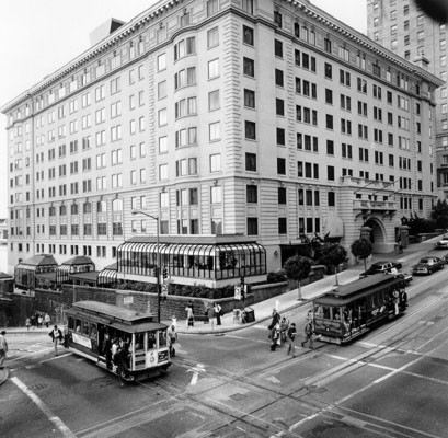 [Two cable cars crossing outside the Stanford Court Hotel, California and Powell streets]