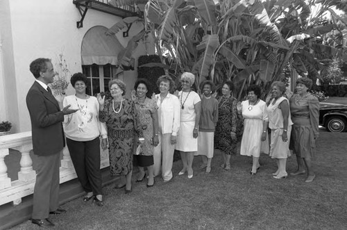 Alpha Wives Auxiliary members raising their hands during an installation ceremony, Los Angeles, ca.1989