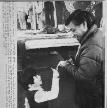 Cesar Chavez, President of United Farm Workers receives a button from Alfred Rodriguez at a rally