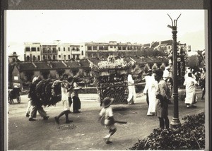 Chinese funeral in Kowloon. Photograph by Rev. Weickum, Fopin. The seat of the spirit with a photograph of the deceased is carried past. The wreaths are probably an idea borrowed from the Europeans