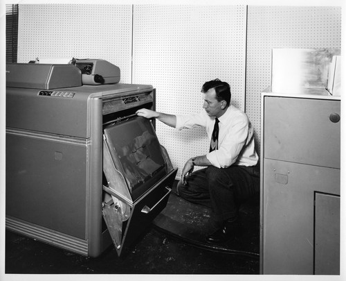 Unidentified Male Inspecting the Mechanisms of an IBM Data Processing Machine