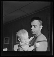 Joe Johnson holding baby, California Labor School