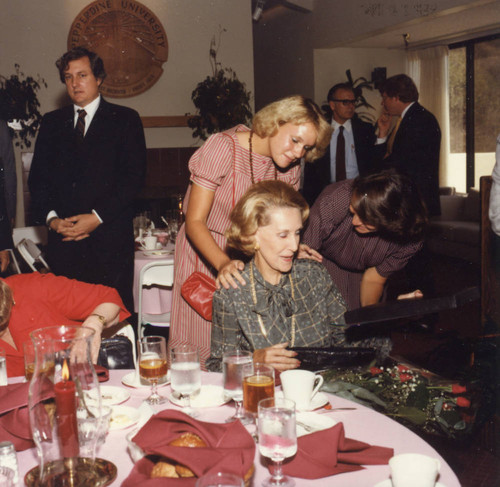 Women speaking to Mrs. Flora Thornton at the luncheon