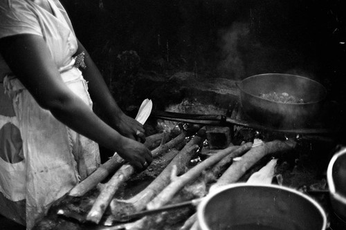 A woman uses a wood burning stove to cook food, San Basilio de Palenque, 1977