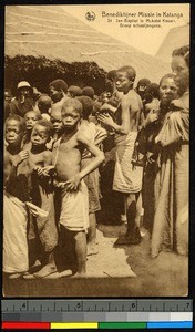 School children standing outside a thatched school, Congo, ca.1920-1940