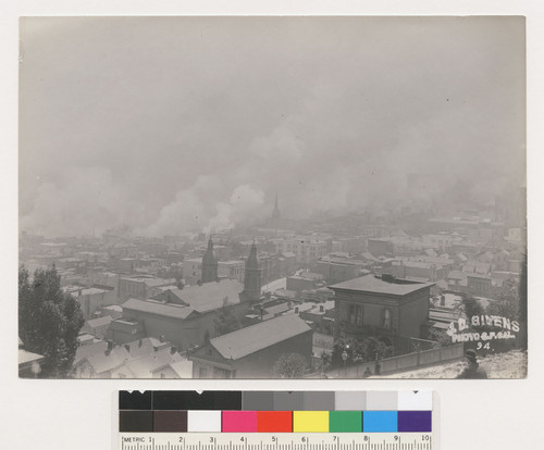 [Cityscape showing fire burning in distance. From unidentified location. No. 94.]