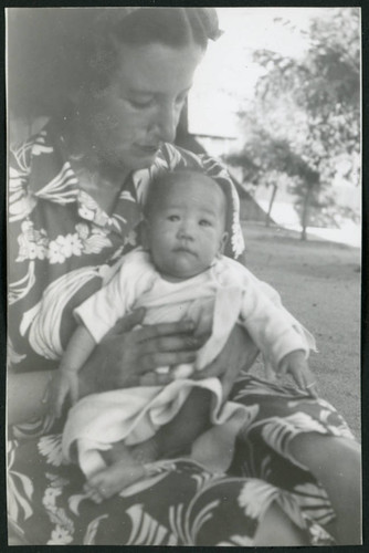 Photograph of Irene Gavigan holding a newborn