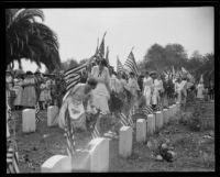 Women decorating graves at Rosedale cemetery, Los Angeles, 1922
