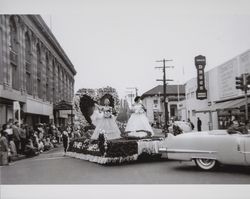 Chamber of Commerce float carries Miss Sonoma County in the Rose Parade, Santa Rosa, California, about 1956