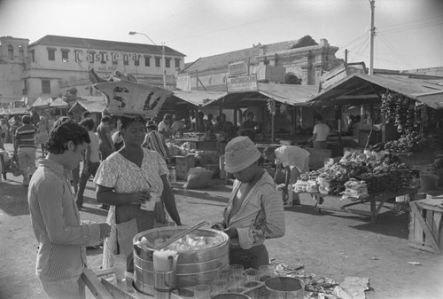 Boy selling drinks at city market, Cartagena Province, ca. 1978