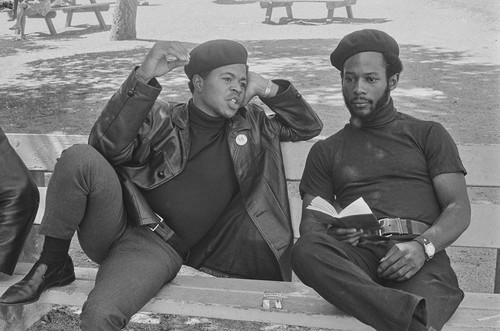 Black Panthers discussing their reading material, Bobby Hutton Memorial Park, Oakland, CA, #101 from A Photographic Essay on The Black Panthers