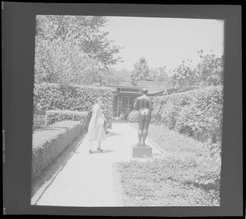 [Candid photographs of House Beautiful staff]. Carolyn Murray in garden, Pulitzer residence