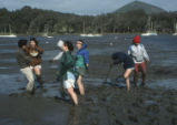 Students dig in mud
