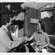 Barbara Maat, hiker, is greeted at Sutter's Fort by State Park Ranger Roger Williams