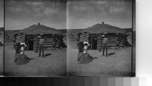 A Navaho and his family in front of a Hogan near Ft. Defiance, Ariz