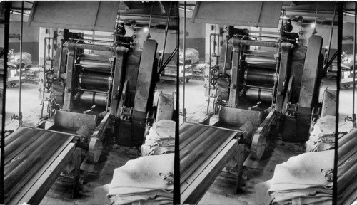 Rear view of tread calendar having four rolls- rubber is coming out to be used for treading purpose, Akron, Ohio