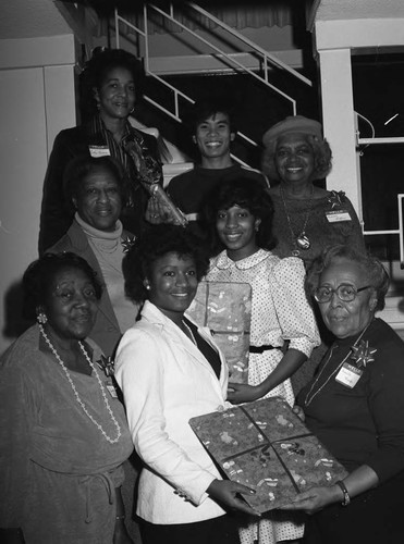 Alpha Gamma Omega sorors and Job Corps members posing together at a Christmas party, Los Angeles, 1983