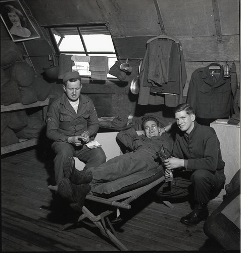 Three soldiers at ease in base barracks