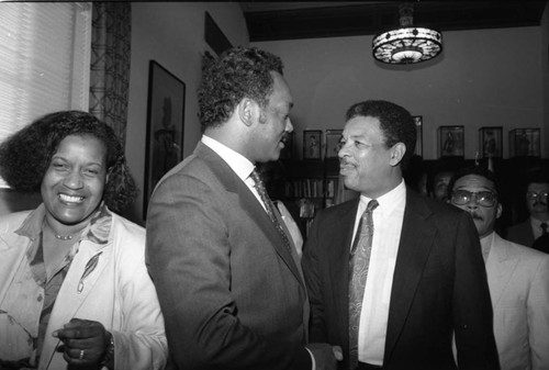 Merlie Evers and Jesse Jackson talking with others in the mayor's office, Los Angeles, 1988