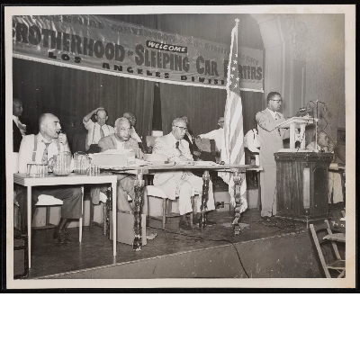 C.L. Dellums, Ashley Totten, and A. Philip Randolph on stage at a session of the 28th anniversary of the Brotherhood of Sleeping Car Porters, Los Angeles Division