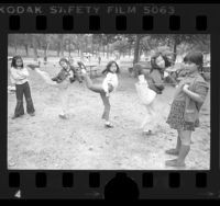Five girls playing Chinese jump-rope at Elysian Park in Los Angeles, Calif., 1976