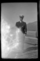 Assistant Purser posing on the wharf, Valdez, 1946