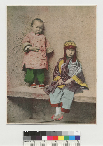 [Two children; one in costume]