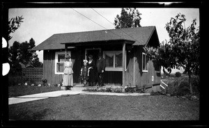 People on the porch of a small home in San Diego