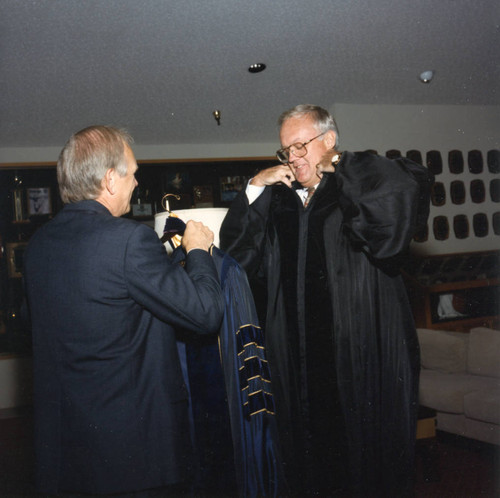 Dean Wilburn assisting Russell Ray with his robe