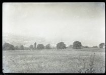 Looking into distance across wide field towards a city