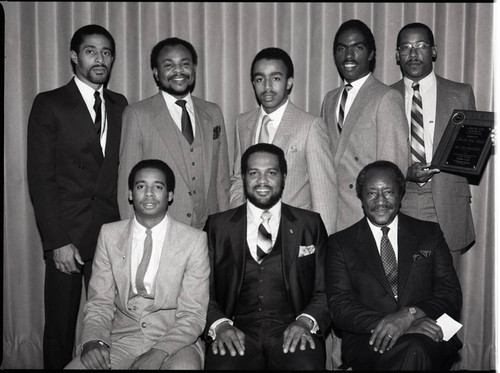 Eight African American men posing for a group portrait, Los Angeles, 1983