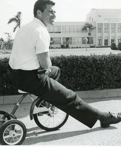 Merlyn Lund on a tricycle in front of the 79th Street Administration Building