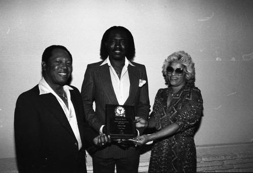 Benjamin Wright holding an award at the Pied Piper nightclub, Los Angeles, 1984