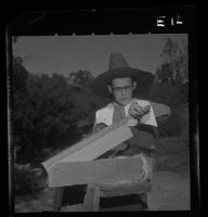 Wallace Farelly, University Elementary School student, operates flax brake, 1958