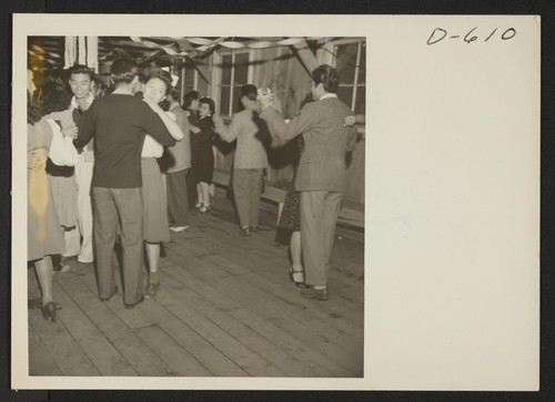 Dance in the social hall at this War Relocation Authority center where evacuees of Japanese ancestry are spending the duration. Photographer: Stewart, Francis Manzanar, California