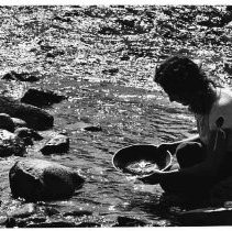 A man pans for gold in the American River at Coloma