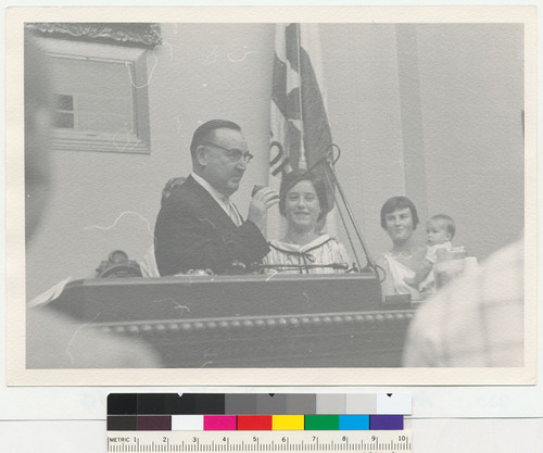 [Edmund G. Brown in front of a microphone with his daughter Kathleen.]